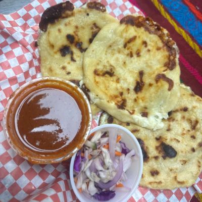 Close-up of pupusas with red salsa
